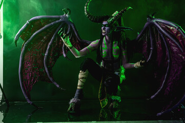 Demon Hunter Demon Cosplay on Black Background in Green Light