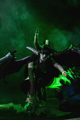Demon Hunter Demon Cosplay on Black Background in Green Light