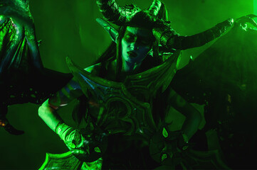 Demon Hunter Demon Cosplay on Black Background in Green Light