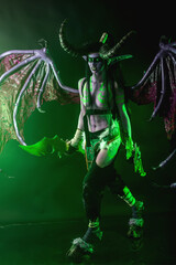 Demon Hunter Demon Cosplay on Black Background in Green Light