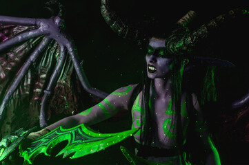 Demon Hunter Demon Cosplay on Black Background in Green Light