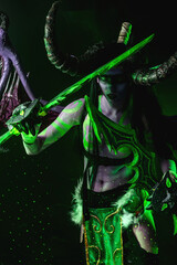 Demon Hunter Demon Cosplay on Black Background in Green Light