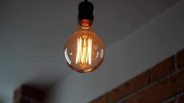 Vintage edison light bulb glowing with exposed filament, rustic ambiance