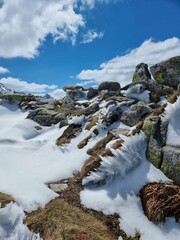 Snowy peaks in the Polish Tatras, a vibrant winter alpine scene under a blue sky.