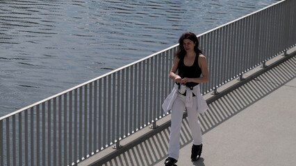 A woman in stylish sportswear jumps in Kangoo Jumps boots, balancing her movements against the...
