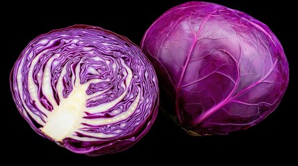 Obraz premium Cut red cabbage exposing its layers, and whole, isolated on black backdrop