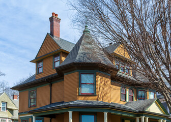 Elegant Victorian style home with striking turret and intricate gable details in Brighton, Massachusetts, USA
