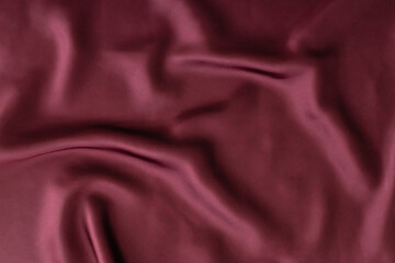Red wine color silk background. Minimal background and texture concept. Trendy cloth backdrop. Flat lay style wallpaper. Top view banner. Copy space.
