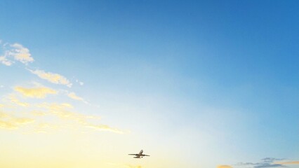ULTRA HD. Airplane flies in sunset sky. Travel. Airplane takes off against the background of sunset sky.