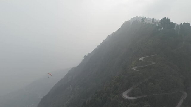 Drone shot 4k. Aerial view of the foggy day in Pelling, Sikkim. Sikkim mountains. Northern India. Indian Mountain. D Log Footage. Bird eye View. Travelling Northeast. Cinematic Paragliding Video Hd+