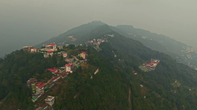 Aerial, drone shot 4k. Aerial view of the foggy day in Pelling, Sikkim. Northern India. Indian Mountain. D Log. Bird eye View. Travelling Northeast Video. Indian mountain village. IN front of Skywalk.