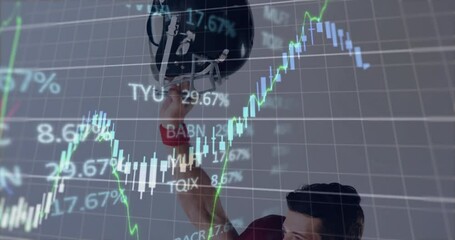 Football player holding helmet over financial stock market graph animation - Powered by Adobe