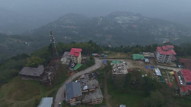 Aerial, drone shot 4k. Aerial view of the foggy day in Pelling, Sikkim. Northern India. Indian Mountain. D Log. Bird eye View. Travelling Northeast Video. Indian mountain village. IN front of Skywalk.