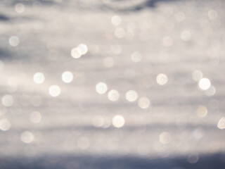 Artistic, shiny, purposely blurred background with white and colorful bokeh effect of snow in...