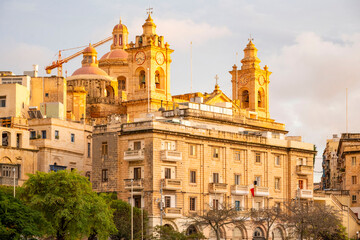 Naklejka premium The Collegiate Church of Saint Lawrence in Vittoriosa, Malta. Waterfront view Il-Birgu. View of the Church 