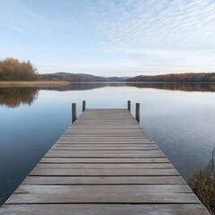 Naklejka premium Wooden dock extends to calm autumn lake reflecting trees