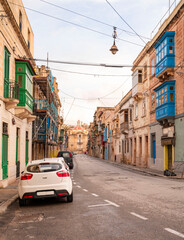 The nearly empty St. Margaret Street in Cospicua. Perhaps a reflection of the times. Triq Santa Margerita, Bormla.Cospicua,View at St Paul's Church Cospicua through a street with many colorful bay 