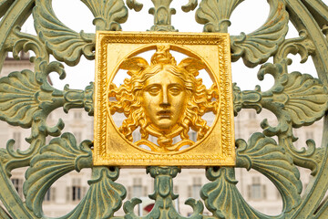 Gates of the Royal Palace 1840 in Turin ,Piedmont, Italy . Wall detail at the Royal Palace of Turin,Italy. Golden mask on the wall of the royal palace