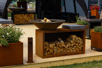 Setting up a picnic area in the backyard. Decorating the lounge area with firewood. Minimalistic and modern design of the recreation area in the backyard or glamping
