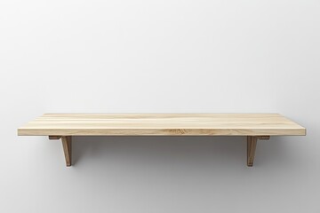 Empty light-colored wooden shelf against a plain white wall