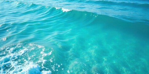 Fototapeta premium Calm blue turquoise ocean surface with gentle waves and foam, ocean movement, wave patterns