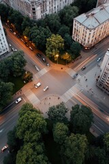 Busy city intersection at dusk with vehicles and pedestrians in a vibrant urban setting