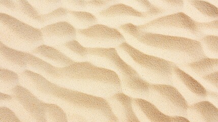 Close-up of desert sand surface showing organic ripples and smooth grain texture in warm tones.