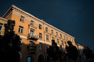 Historic building on Didžioji Street 20, Vilnius, Lithuania, bathed in warm sunlight against a...