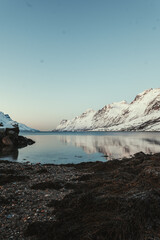 Snowy mountain reflection in Ersfjord arctic ocean near Tromso, Norway. © Benjamin