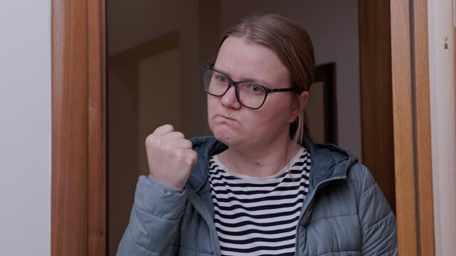 Woman with glasses, strict mother in doorway, shocked by a prank, shaking her fist, indignant, opening her mouth in amazement Teacher returned to class and scolded her for poor discipline Family abuse