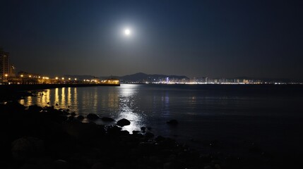 Obraz premium Moonlit waterfront city at night