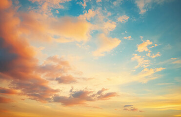 Fototapeta premium A view of a colorful sky with orange and blue hues and soft fluffy clouds during the sunset hour