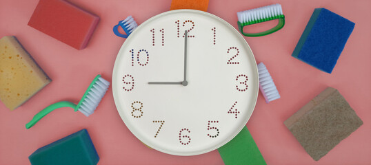 Clock showing nine on cleaning supplies background, wall clock displaying 9 o’clock, kitchen sponges and cleaning brushes, banner for cleaning company, housekeeping advertisement, website header