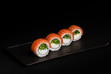 Delicious Fresh Salmon Sushi Rolls Presenting Exquisitely on a Black Background