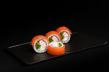 Delicious Fresh Salmon Sushi Rolls Presenting Exquisitely on a Black Background