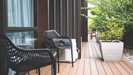 Building exterior outdoor deck chairs table in the garden relaxing place hotel yard balcony