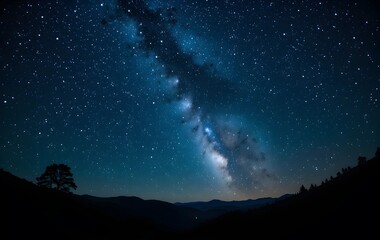 Breathtaking View of the Milky Way Galaxy Stretching Across the Night Sky Over a Mountain Landscape with Silhouetted Trees