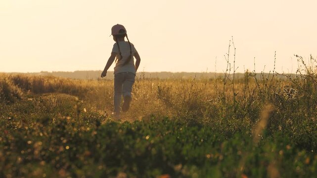 little girl running along a rural road at sunset, wheat field, children's dream running, child kid daughter girl running happy at sunset, view from the back, view from the back, children running at