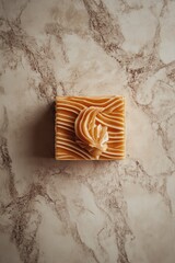 Square, light-brown soap bar, textured design
