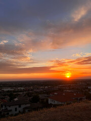 Majestic Sunset Over the Hills With Vibrant Colors Illuminating the Sky in a Peaceful Neighborhood