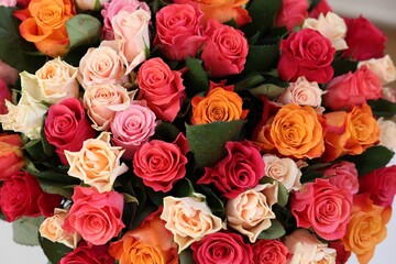 Bouquet of beautiful roses as background, top view