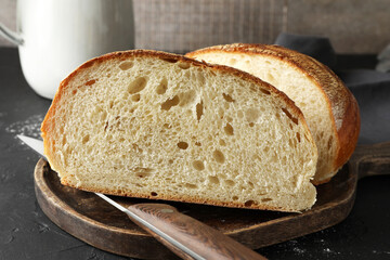 Pieces of fresh bread on black table, closeup