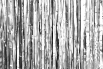 Fototapeta premium Shiny silver foil curtain as background, closeup