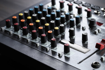 Professional mixing console on table, closeup. Radio studio equipment