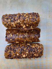 Sweet delicacies are presented, showcasing crunchy nuts enveloped in rich caramel, appealing to bakery lovers