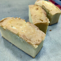 Soft, moist slices of pound cake are arranged neatly next to a whole cake, showcasing their texture and color in the bakery
