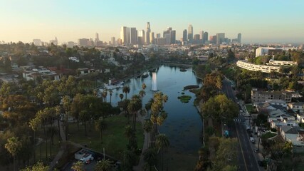 Breathtaking aerial drone footage captured in the morning light of Echo Park Lake highlights the stunning beauty and vibrant landscape of downtown Los Angeles skyline, California, in all its glory - Powered by Adobe
