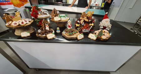 A colorful assortment of holiday baked goods is arranged beautifully on display at a bakery, highlighting seasonal creativity and craftsmanship
