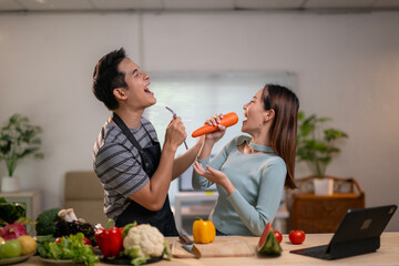 A man and a woman are eating a carrot