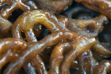 Popular sweet snack of South and Western Asia, named Jalebi, also known as Jilapi, zulbia, mushabak and zalabia, displayed for Sale. Selective Focus is used.